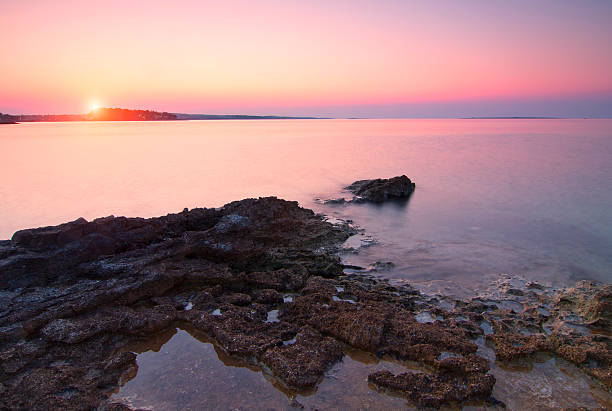 istock Sunrise over rocky beach 488387000