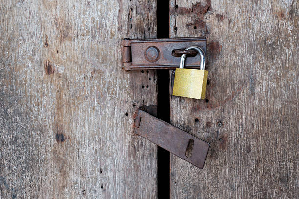 istock Old rusty padlock on old wooden door. 488388006
