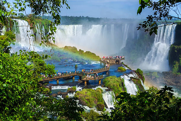 Tourists at Iguazu Falls, Foz do Iguacu, Brazil Tourists at Iguazu Falls, one of the world's great natural wonders, near the border of Argentina and Brazil. paraguay stock pictures, royalty-free photos & images