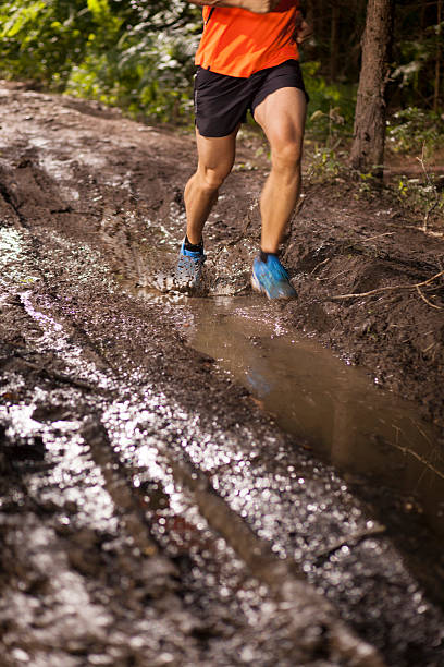 istock Man running through dirt track in ultramarathon race 488390224
