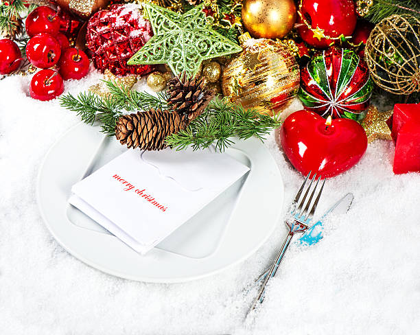 istock christmas table place setting decoration with red candle 488390461