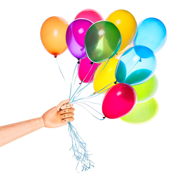 istock wooden hand gives flying balloons 488391445