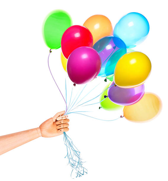 istock wooden hand gives flying balloons 488391447