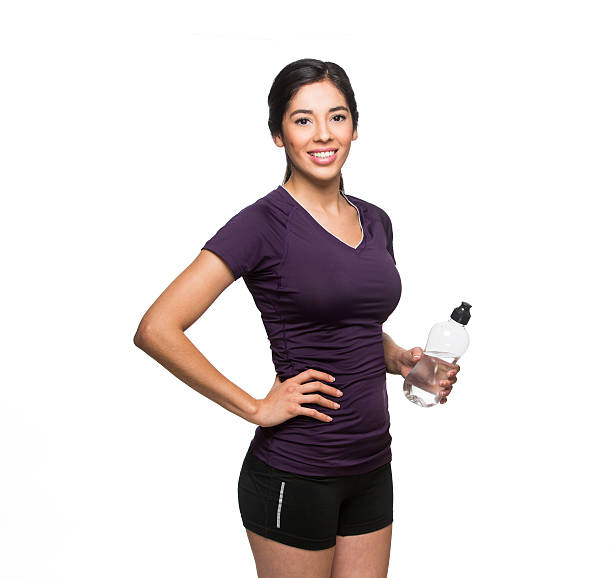 Attractive woman holding a water bottle isolated on white background