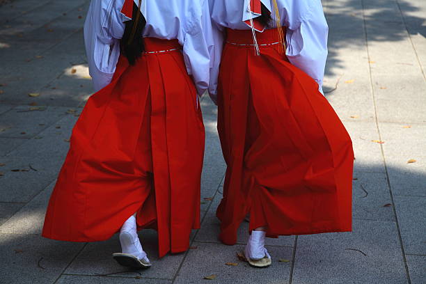 Shrine maiden walking Two Shrine maidens walking at Shinto Shrine. japan women human foot japanese culture stock pictures, royalty-free photos & images