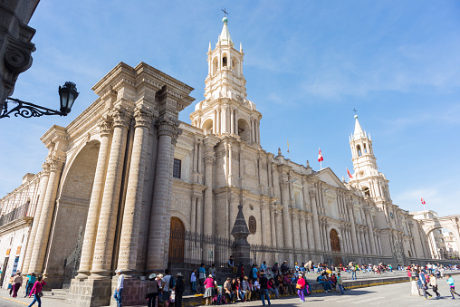 Arequipa, Peru - August 15, 2015: People and tourists visiting Plaza de Armas and the Cathedral in Arequipa, famous travel destination and landmark in Peru.