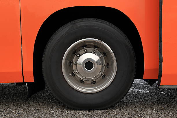 Wheel with damaged rim on a wet road Wheel with damaged rim on a wet asphalted road wheel cap stock pictures, royalty-free photos & images
