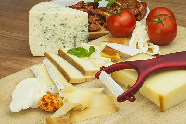 istock Slicing cheese, preparing for the home garden party 488406062