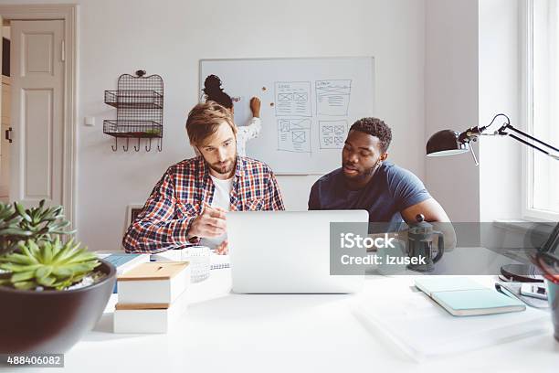 Bearded Blonde Man Working On Laptop With Afro American Colleague Stock Photo - Download Image Now