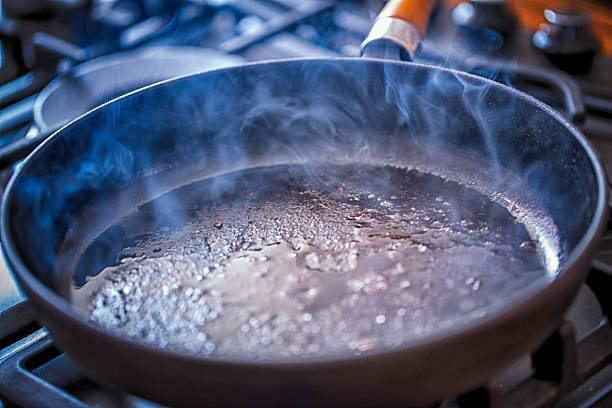 Breaded chicken in frying pan at commercial kitchen