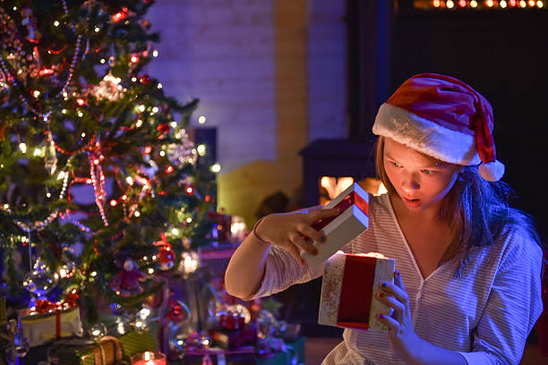 istock Christmastime, an expressive young girl opening her gift-box 488407850