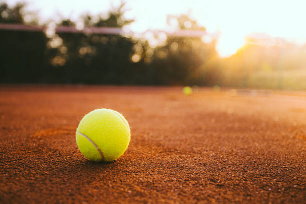 istock Tennis ball on clay court 488410312