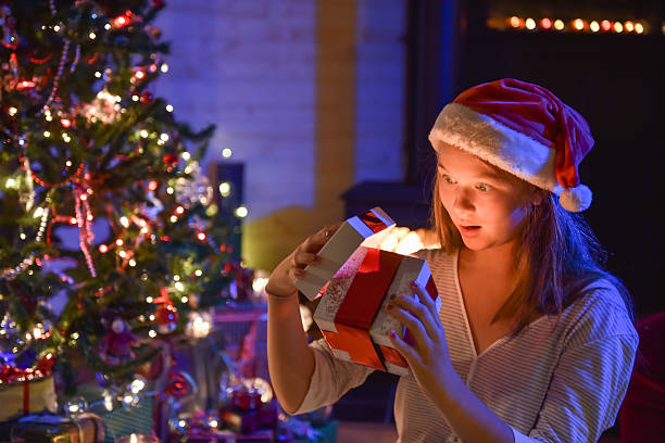 istock Christmastime, an expressive young girl opening her gift-box 488410428