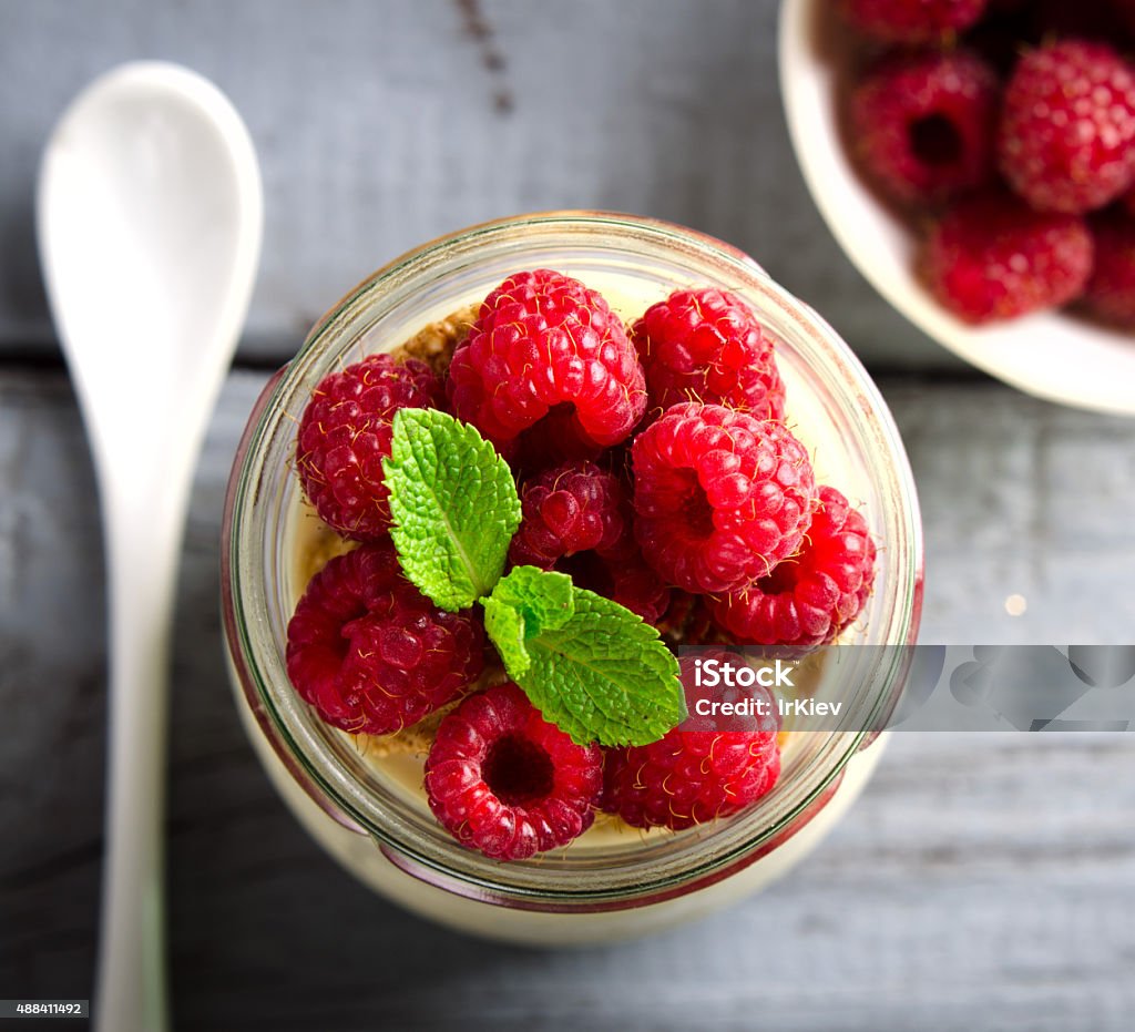 Healthy breakfast - fresh Greek yogurt with raspberries and mint Healthy breakfast - fresh Greek yogurt with raspberries and mint in a glass 2015 Stock Photo