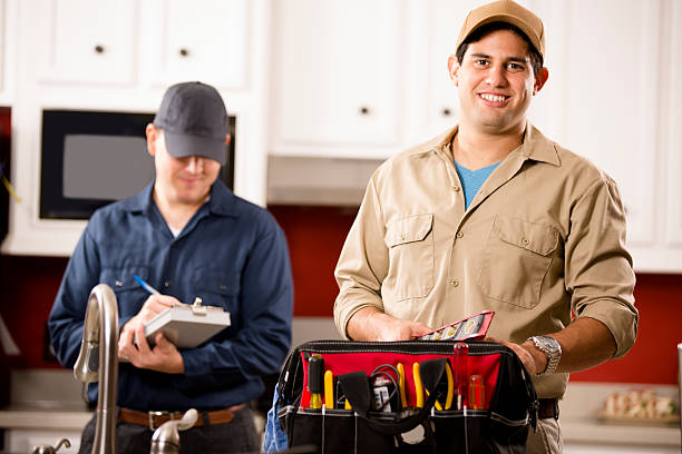 istock Service Industry: Two multi-ethnic repairmen work at customer's home. 488412096