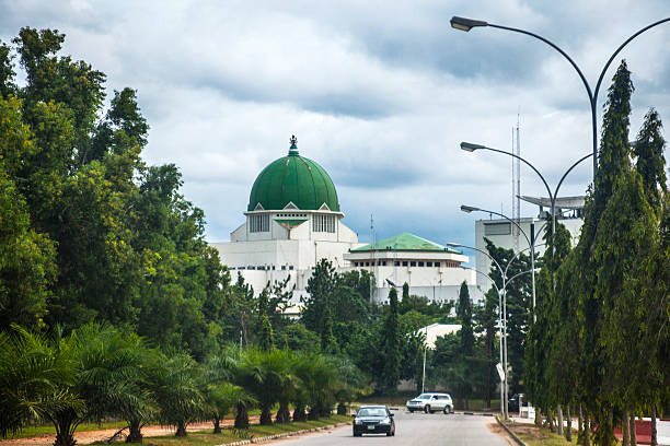 Government buildings in Abuja, Nigeria. The National Assembly building in background. nigeria stock pictures, royalty-free photos & images