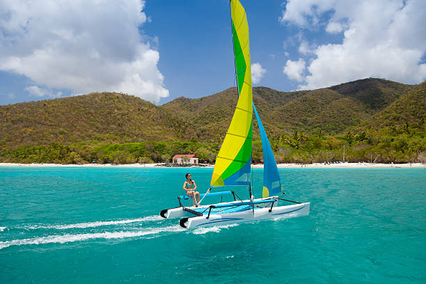 istock woman sailing a catamaran in Cinnamon Bay, St.John, USVI 488412146