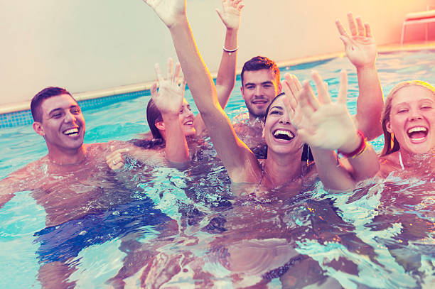 istock Group of happy young people partying in a pool. 488413610