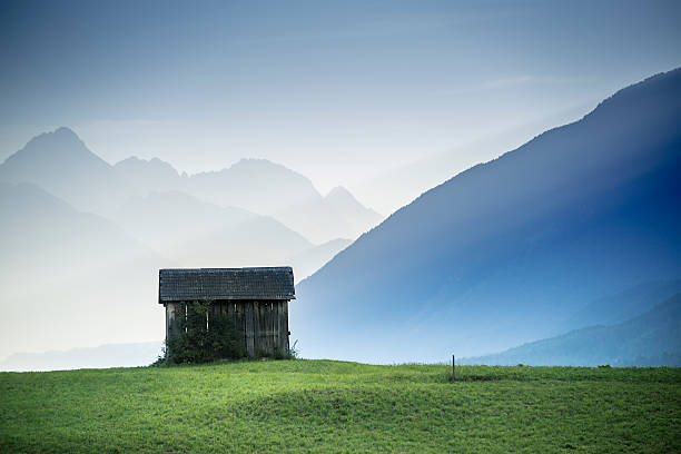 Little wooden shack in the mountains stock photo