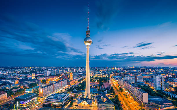 Berlin skyline panorama with TV tower at night, Germany Aerial view of Berlin skyline with famous TV tower at Alexanderplatz and dramatic cloudscape in twilight during blue hour at dusk, Germany. central berlin photos stock pictures, royalty-free photos & images