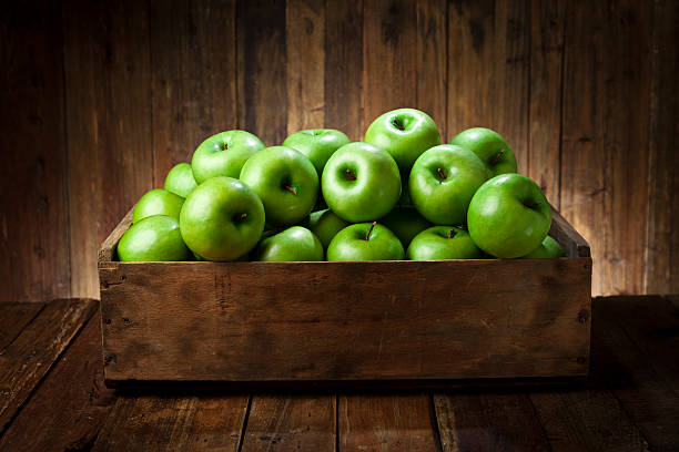 istock Green apples in a wooden crate on rustic wood table 488427682
