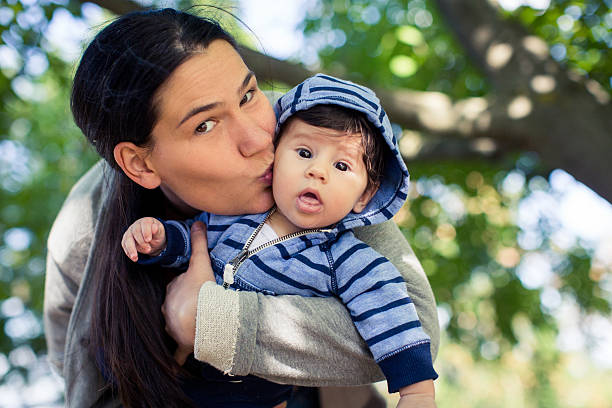 istock Mother kissing her baby boy 488428962