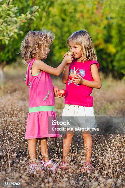 Two Girls With Apples Stock Photo - Download Image Now - 2-3 Years, 2015, 4-5 Years