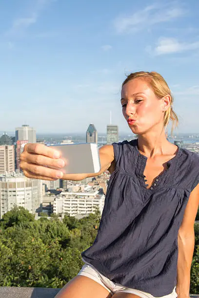 Photo of Student in Montreal taking selfie portrait with mobile phone