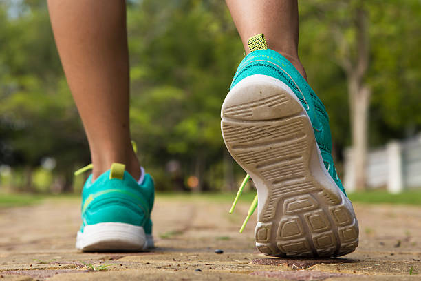 istock Runner feet running on road closeup on shoe 488434360