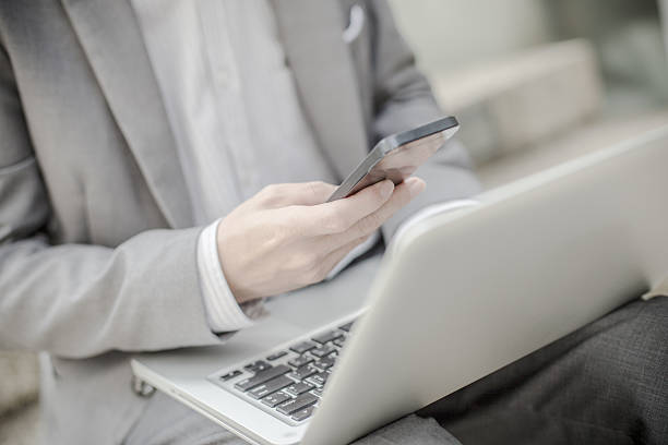 istock Businessman using laptop pc and mobile phone 488434646