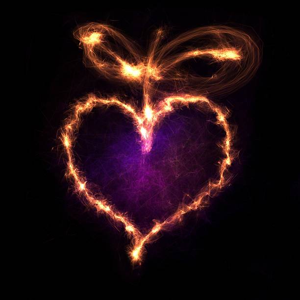 istock Glowing heart shape with sparkles on dark background 488435681