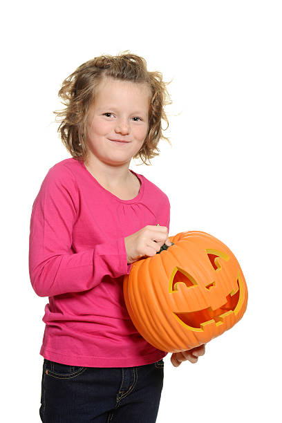 istock happy little girl with pumpkin 488436559