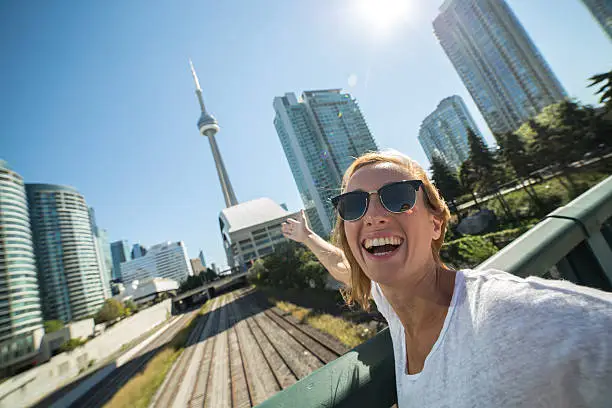 Photo of Woman traveling taking selfie portrait in Toronto