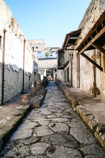 Ercolano, Italy  - October 5, 2008: Ancient Roman Street in Ercolano, some tourists walking in the street, Italy