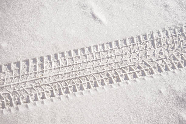 Fresh snow sedan tire track stock photo