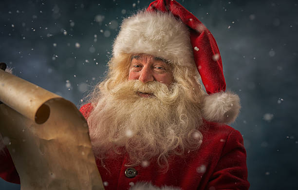 istock Santa Claus reading Christmas letter 488437914