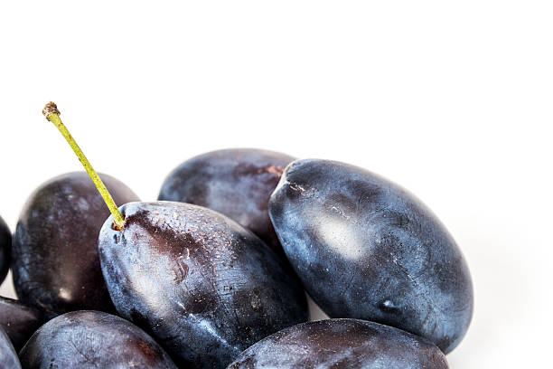 istock Big juicy ripe plums close-up on a white background 488437982