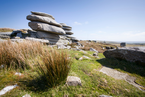 A landscape showing the Cheesewrings on Bodmin Moor, a key land feature to the moors and a popular location for people visiting the area.