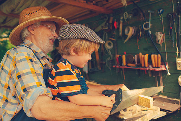 istock Grandfather and grandson in workshop 488438833