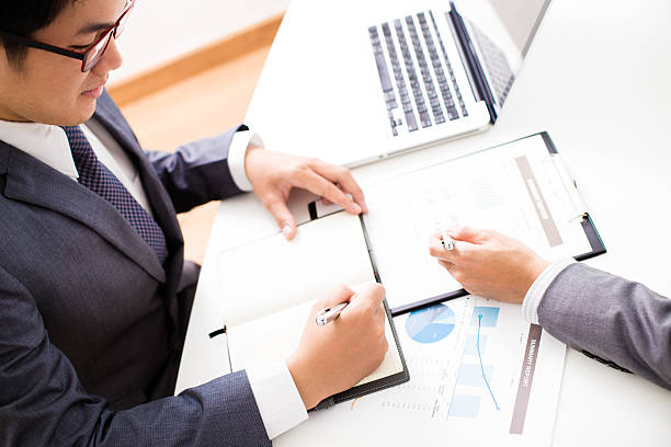 istock Two businessmen looking at report and having a discussion 488439436