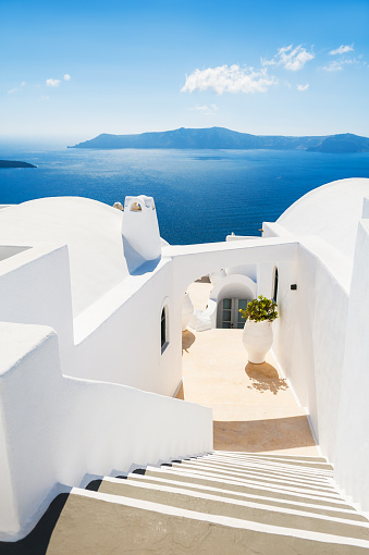 White architecture on Santorini island, Greece. Stairs to the sea. Beautiful landscape with sea view.