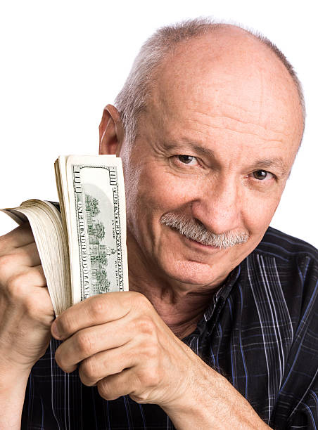 istock Senior man holding dollar bills 488442254
