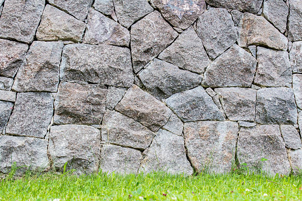 istock background of a stone wall  in a lawn 488443258