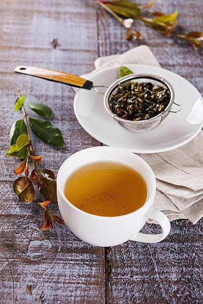 istock Cup of green tea over rustic wooden background 488465486