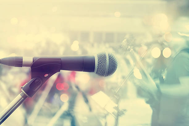 istock Microphone with guitarist on stage, pastel color and soft 488467500
