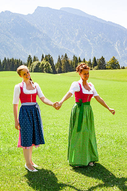 istock Mother and daughter walking both go hand in hand in a dirndl. 488467594