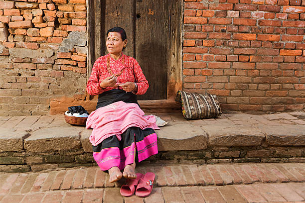 istock Nepali woman spinning the wool 488468080