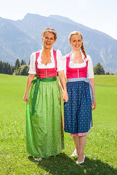 istock Mother and daughter walking both go hand in hand in a dirndl. 488468964