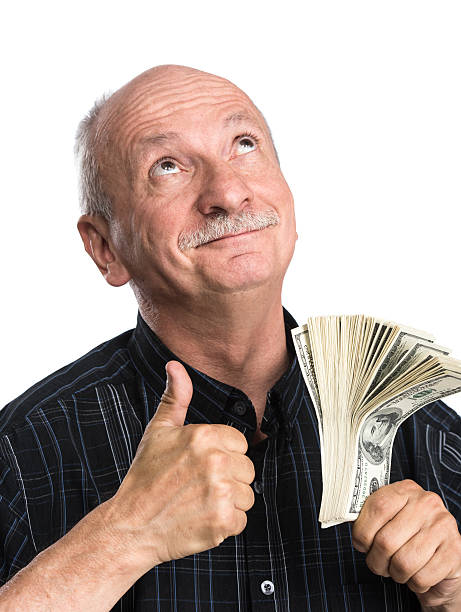 istock Senior man holding dollar bills 488470540