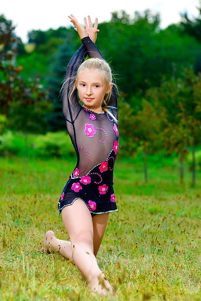 istock flexible little girl doing gymnastics split 488471350